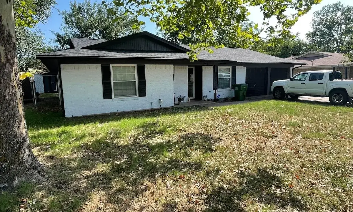 Professional roofing crew working on a residential roof in Swannanoa